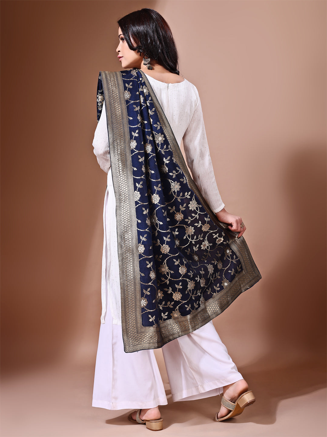 Model in a fancy pose wearing a blue Banarasi bridal dupatta, ideal for wedding wear.