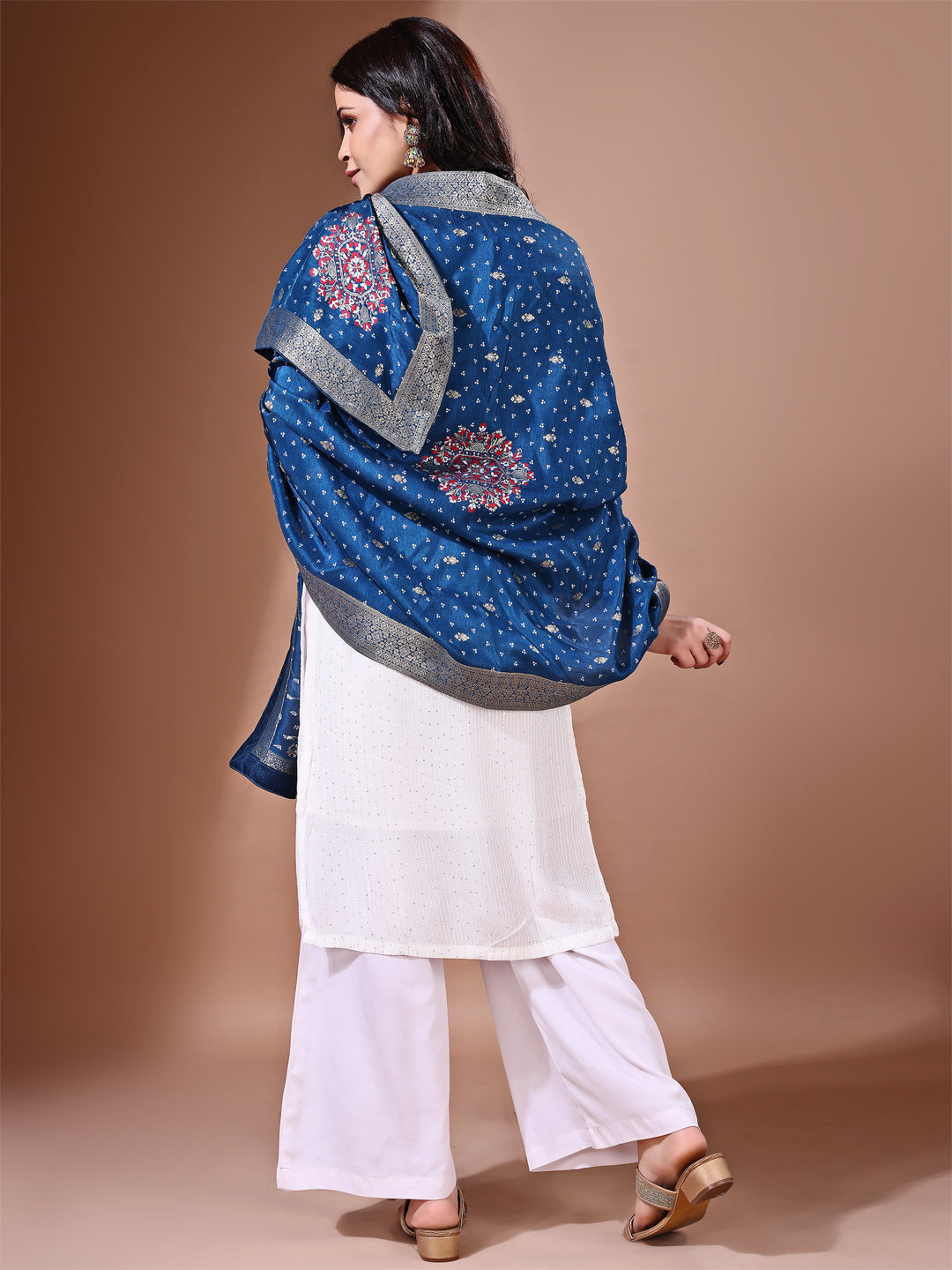 Model in a fancy pose wearing a blue Banarasi bridal dupatta, ideal for wedding wear.