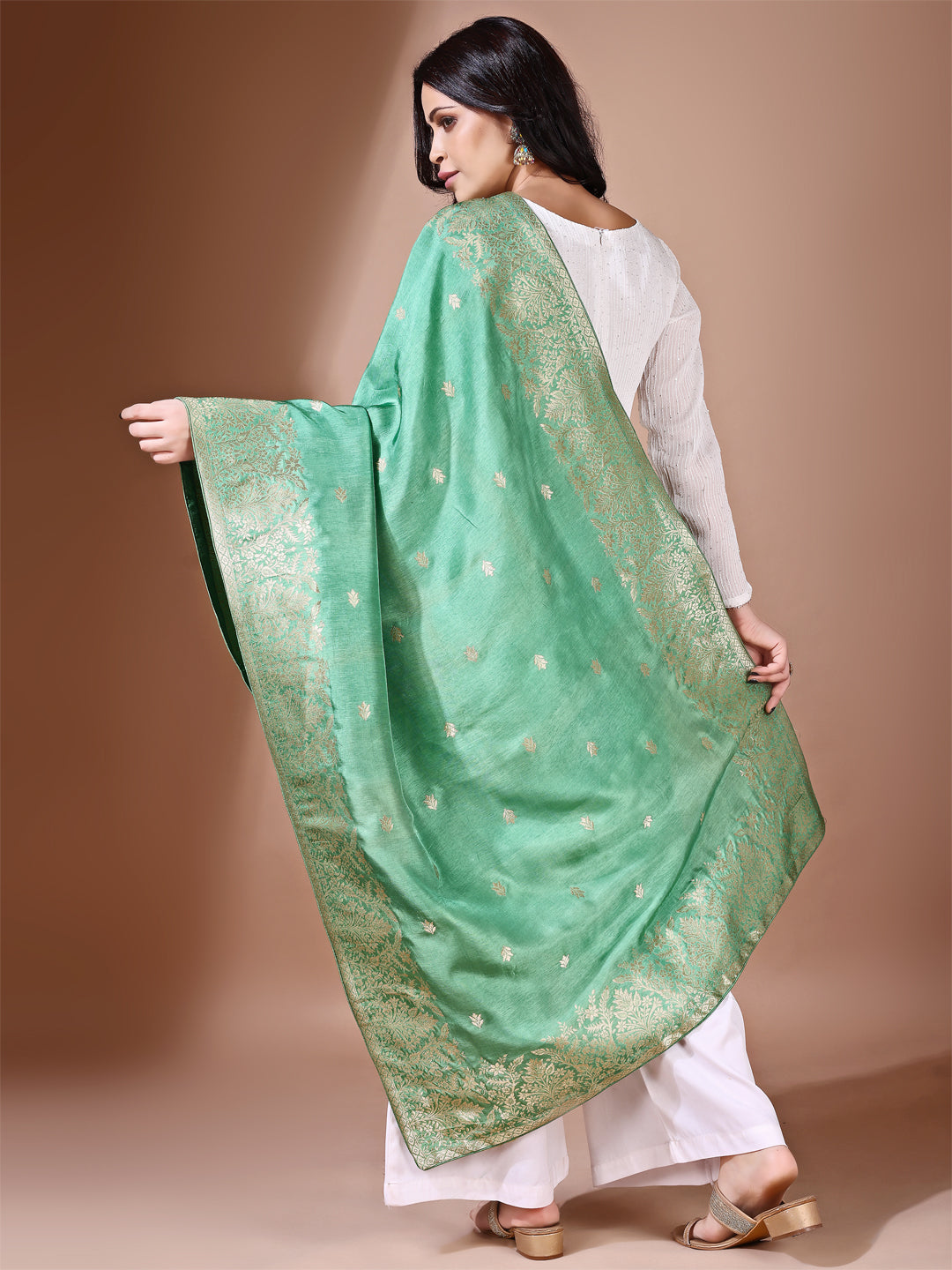 Model in a fancy pose wearing a green Banarasi bridal dupatta, ideal for wedding wear.