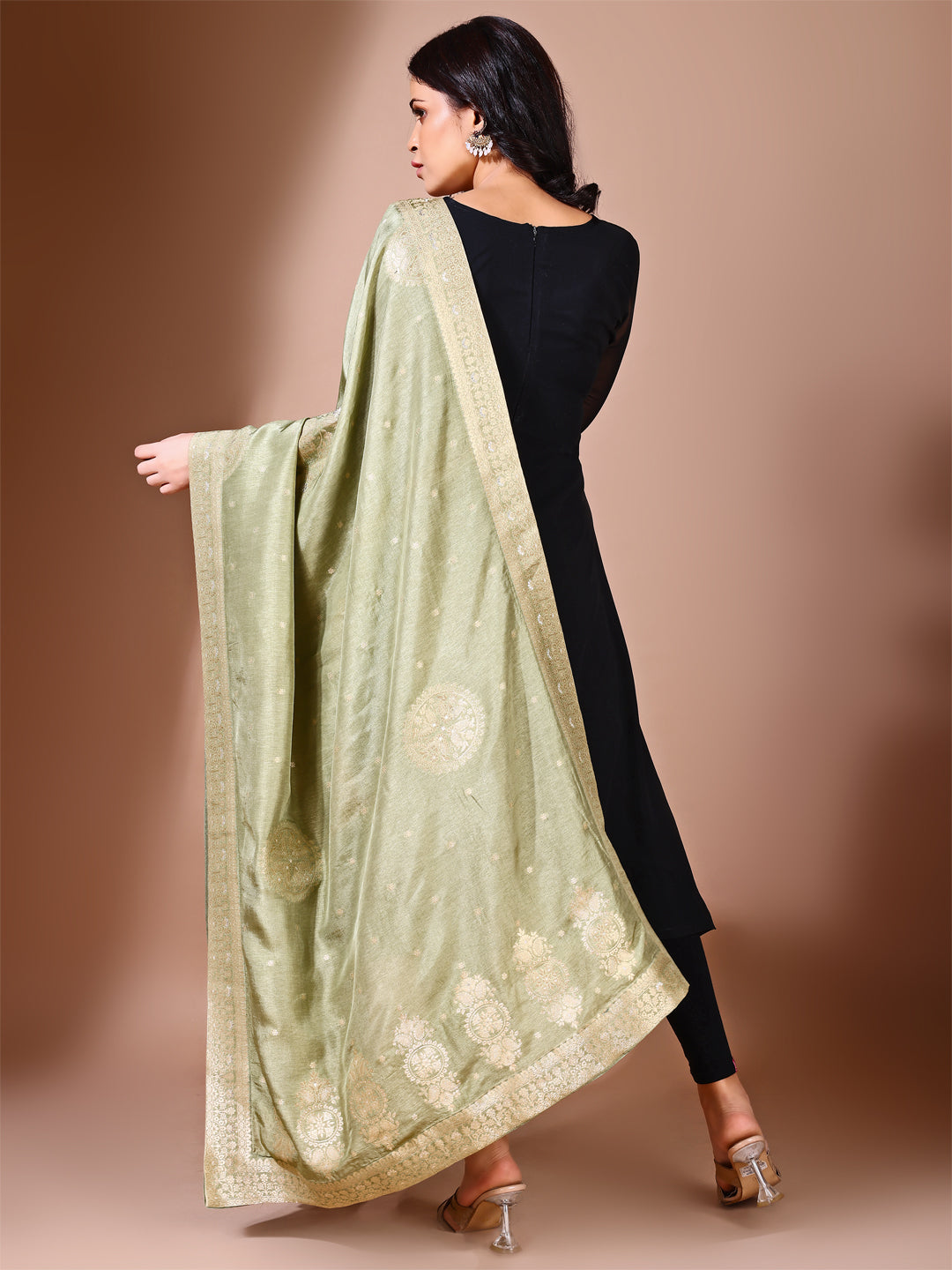 Model in a fancy pose wearing a green Banarasi bridal dupatta, ideal for wedding wear.