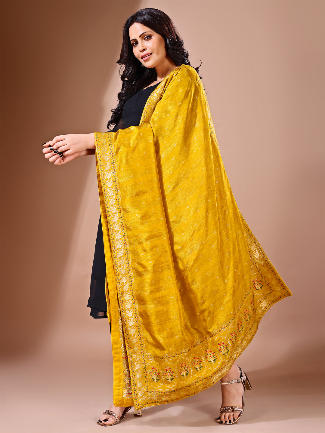 Close-up shot of mustard Banarasi bridal dupatta with intricate zari work, perfect for weddings.