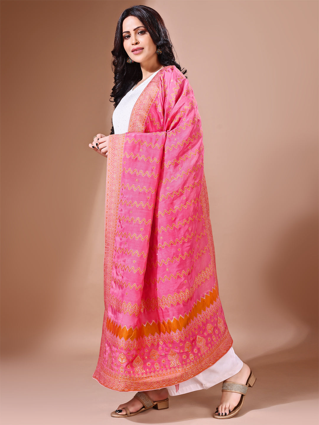 Close-up shot of pink Banarasi bridal dupatta with intricate zari work, perfect for weddings.