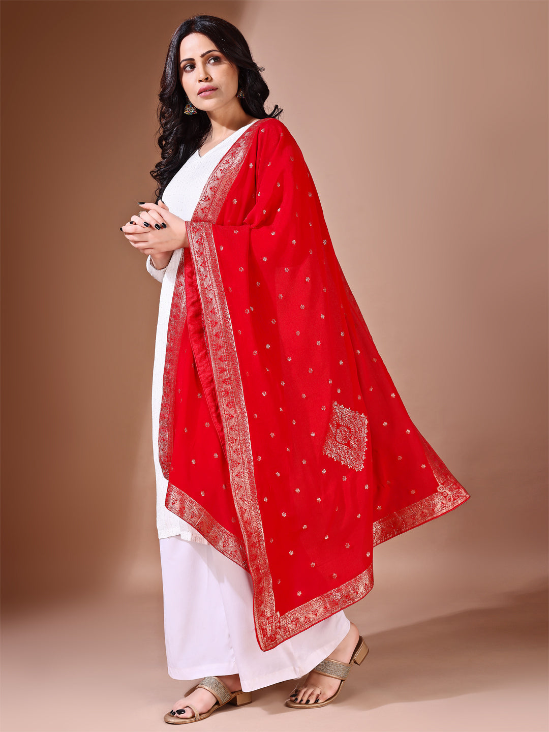 Close-up shot of red Banarasi bridal dupatta with intricate zari work, perfect for weddings.