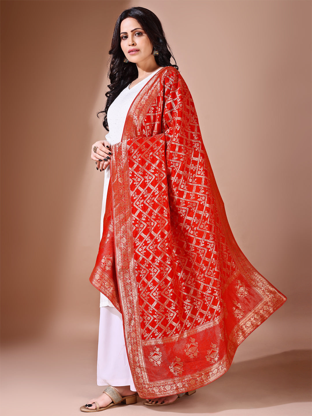 Side pose showcasing the rust bridal dupatta, designed for weddings and special occasions.