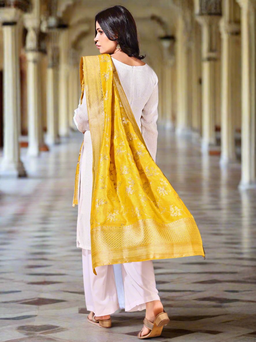 Close-up shot of yellow Banarasi bridal dupatta with intricate zari work, perfect for weddings.