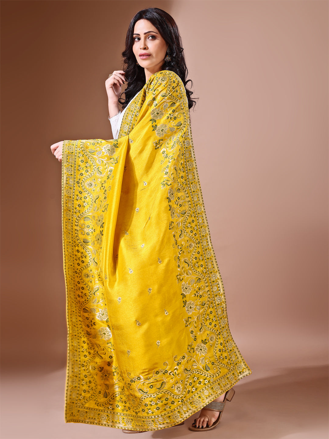 Close-up shot of yellow Banarasi bridal dupatta with intricate zari work, perfect for weddings.