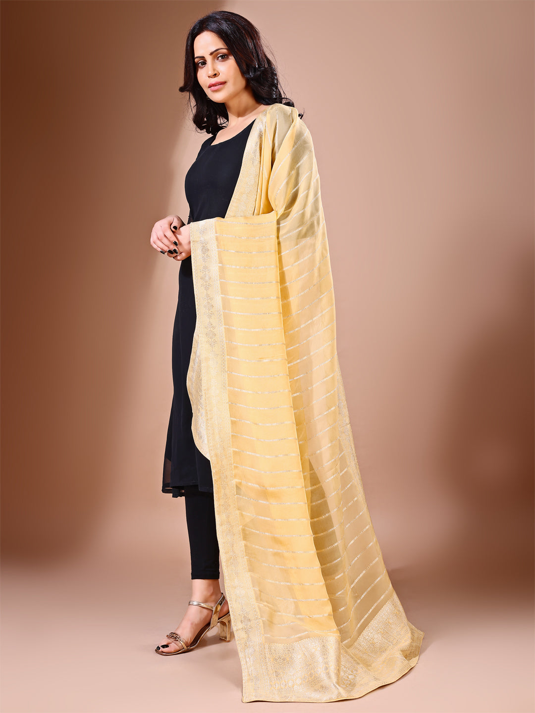 Side pose showcasing the yellow bridal dupatta, designed for weddings and special occasions.