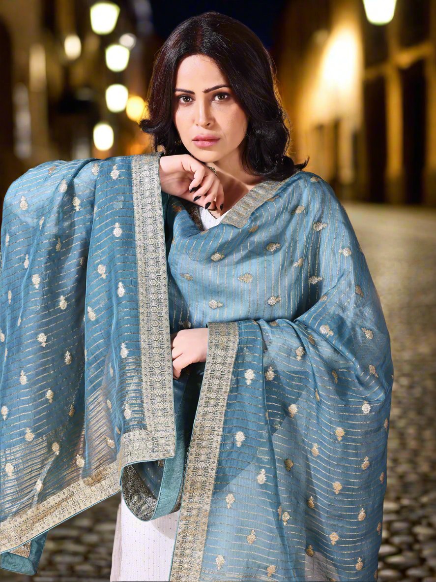 Side pose showcasing the cyan bridal dupatta, designed for weddings and special occasions.