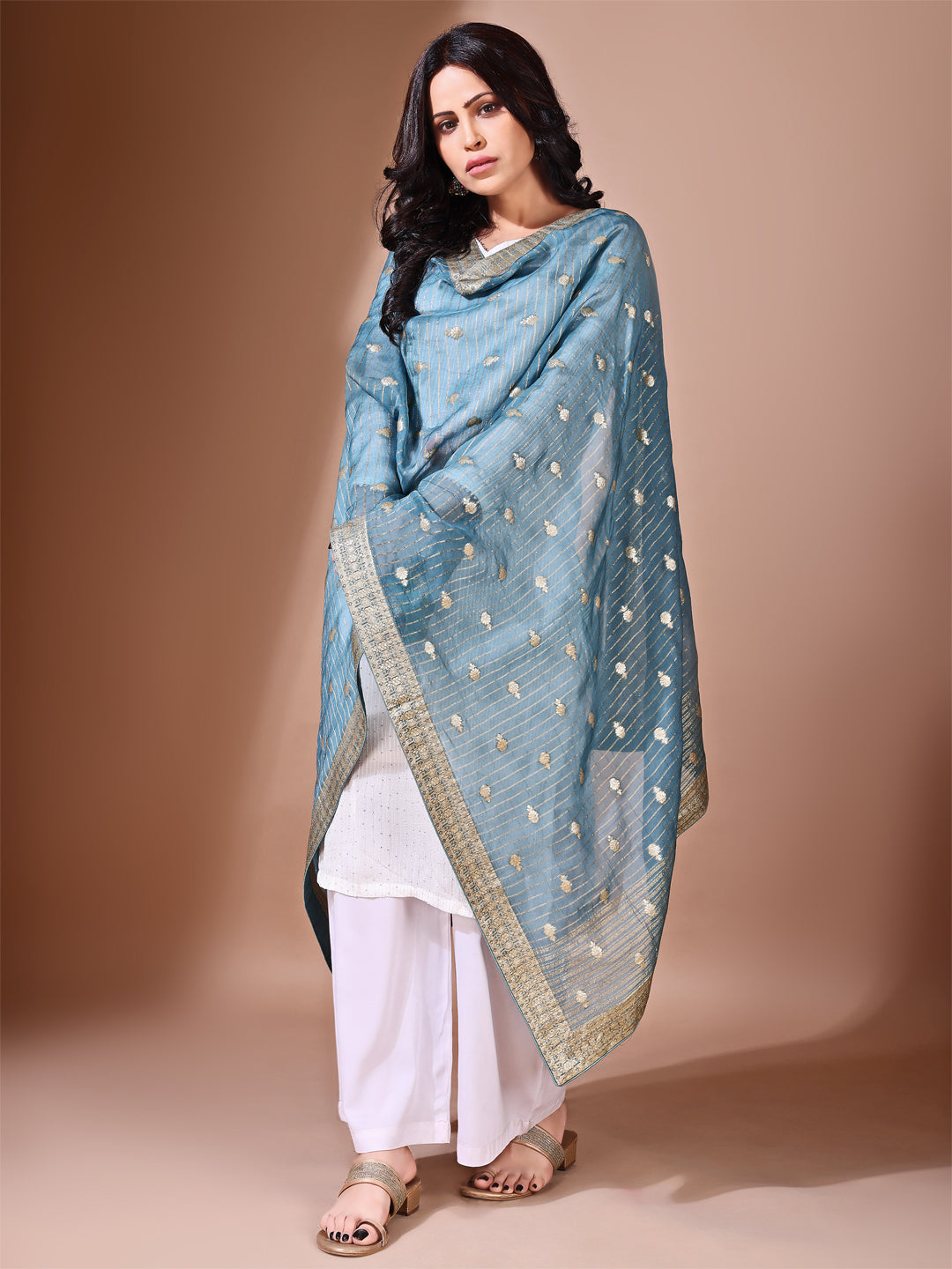 Close-up shot of cyan Banarasi bridal dupatta with intricate zari work, perfect for weddings.