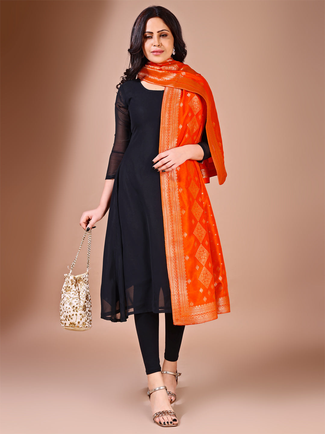 Side pose showcasing the orange bridal dupatta, designed for weddings and special occasions.