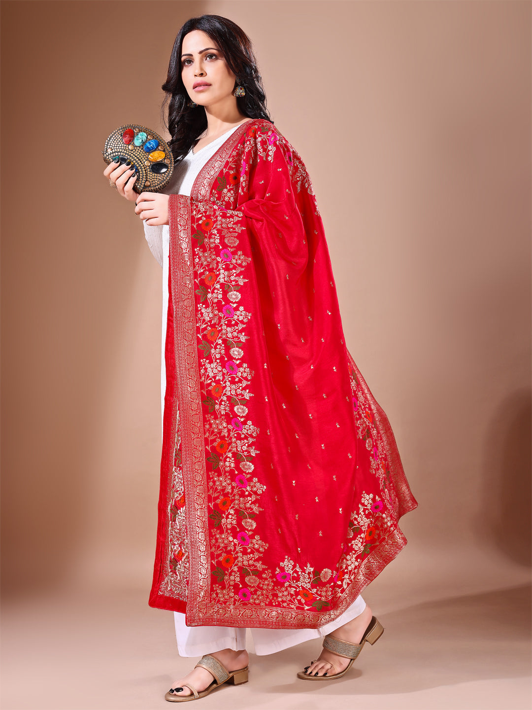 Close-up shot of red Banarasi bridal dupatta with intricate zari work, perfect for weddings.