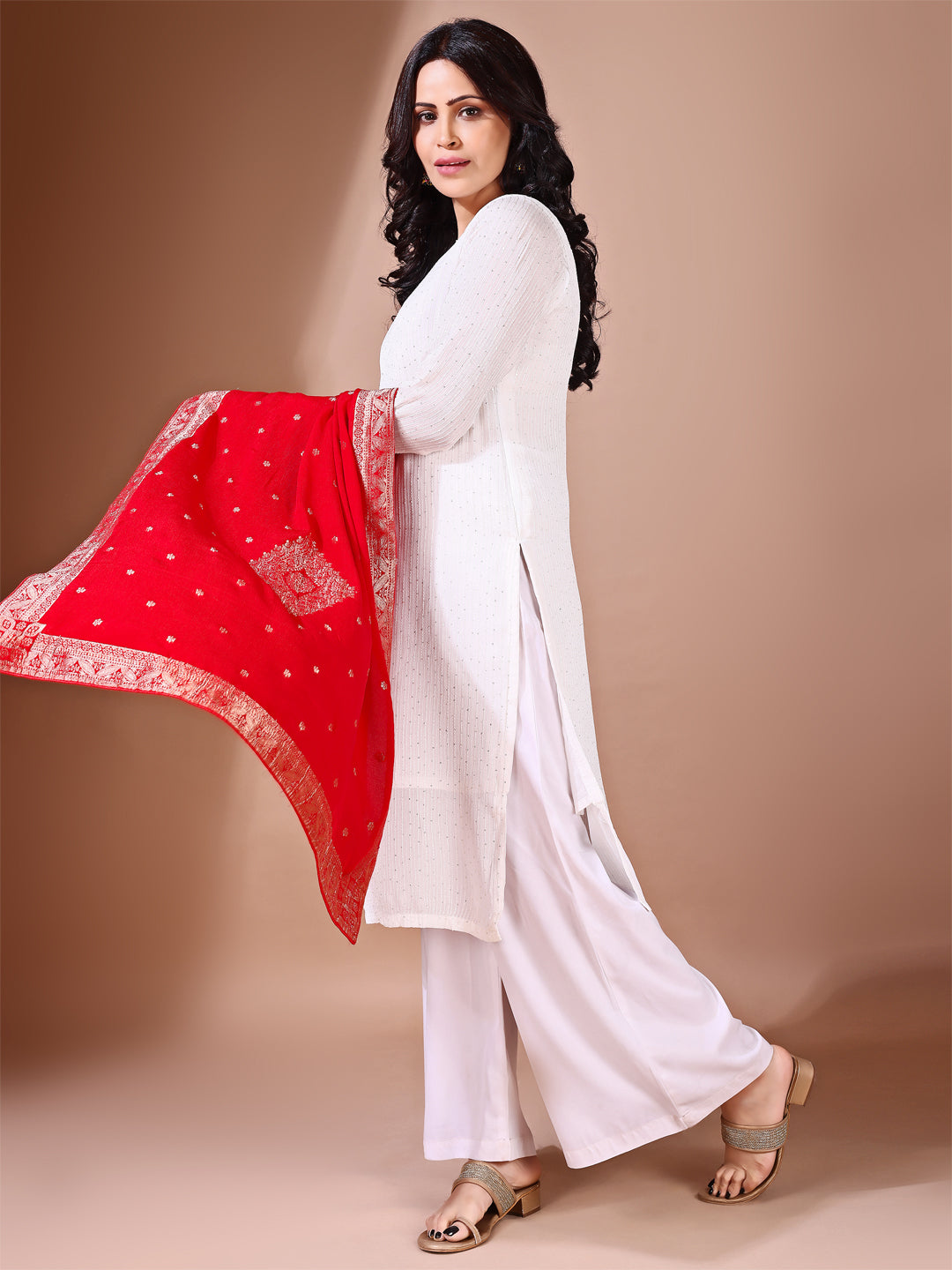 Side pose showcasing the red bridal dupatta, designed for weddings and special occasions.