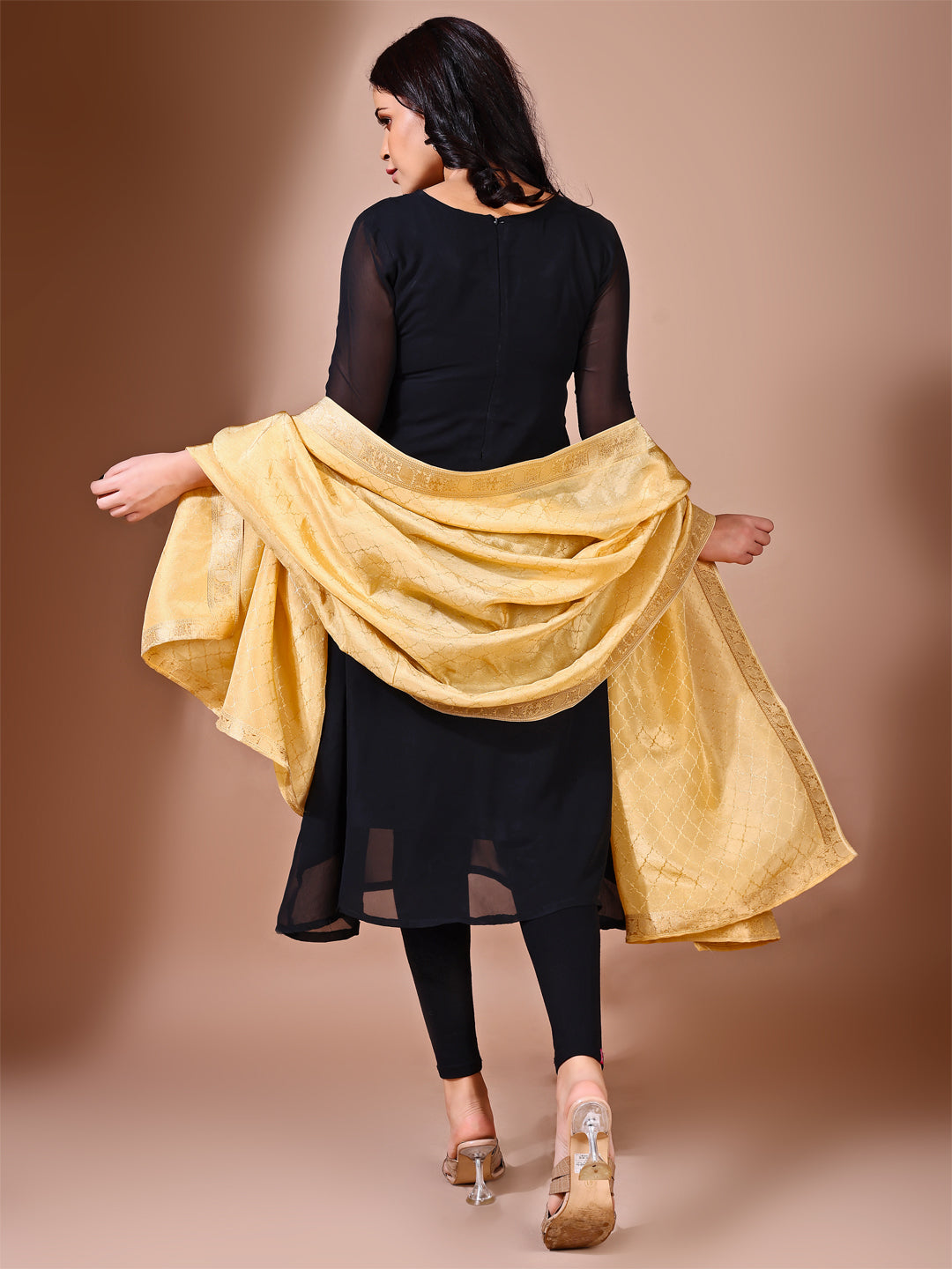 Fancy pose of model in a golden essence dupatta, perfect for weddings and ceremonial gatherings.