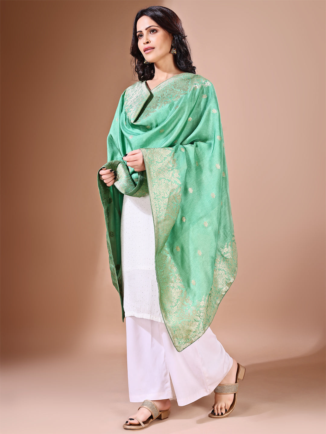 Close-up shot of green Banarasi bridal dupatta with intricate zari work, perfect for weddings.