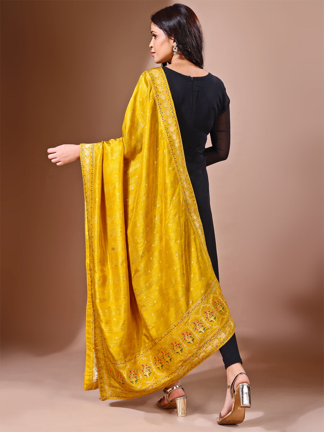 Model in a fancy pose wearing a mustard Banarasi bridal dupatta, ideal for wedding wear.