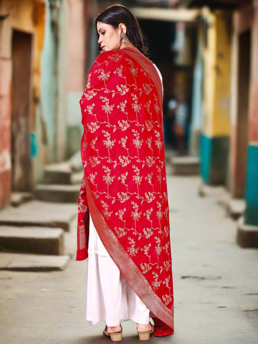 Model in a fancy pose wearing a red Banarasi bridal dupatta, ideal for wedding wear.