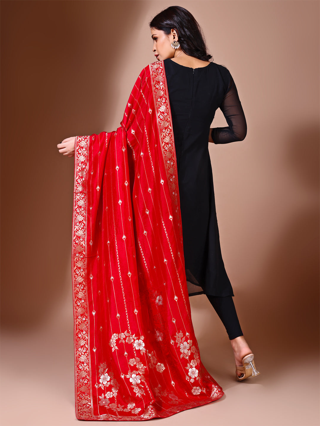 Model in a fancy pose wearing a red Banarasi bridal dupatta, ideal for wedding wear.