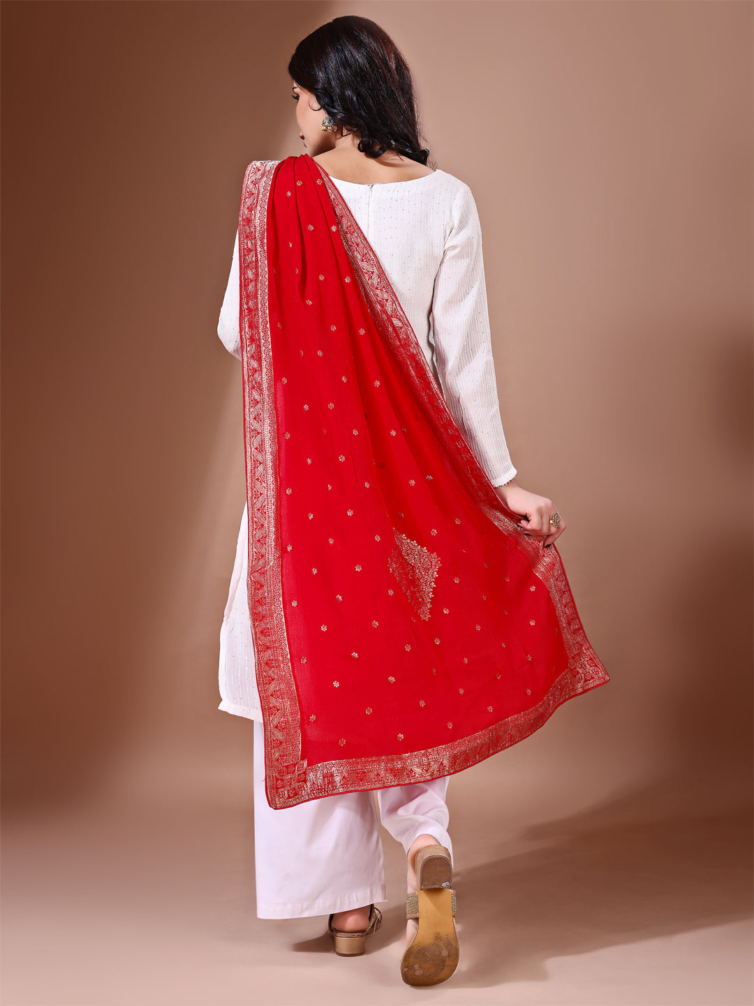 Model in a fancy pose wearing a red Banarasi bridal dupatta, ideal for wedding wear.