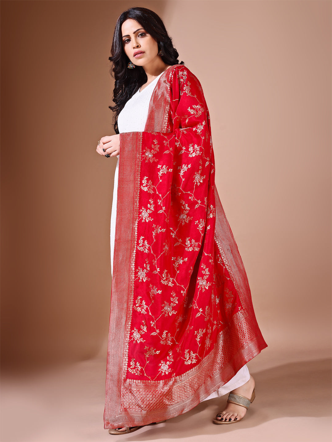 Close-up shot of red Banarasi bridal dupatta with intricate zari work, perfect for weddings.