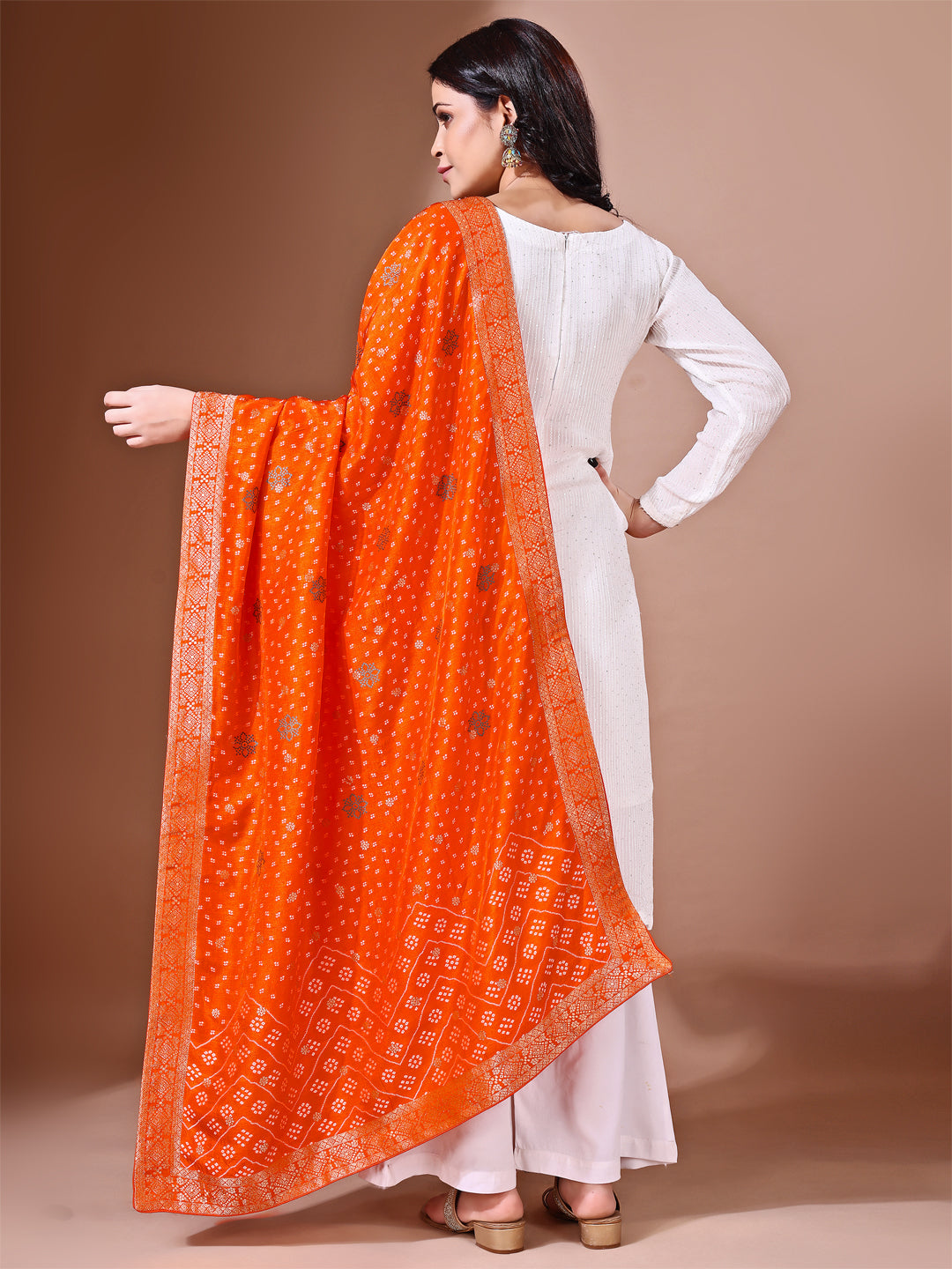 Model in a fancy pose wearing a rust Banarasi bridal dupatta, ideal for wedding wear.