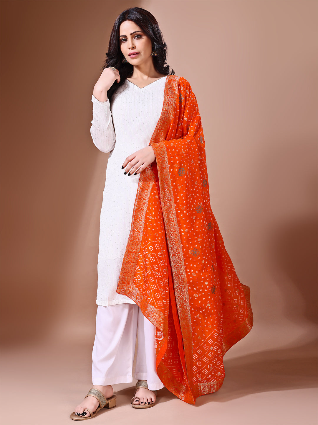 Model in a fancy pose wearing a rust Banarasi bridal dupatta, ideal for wedding wear.