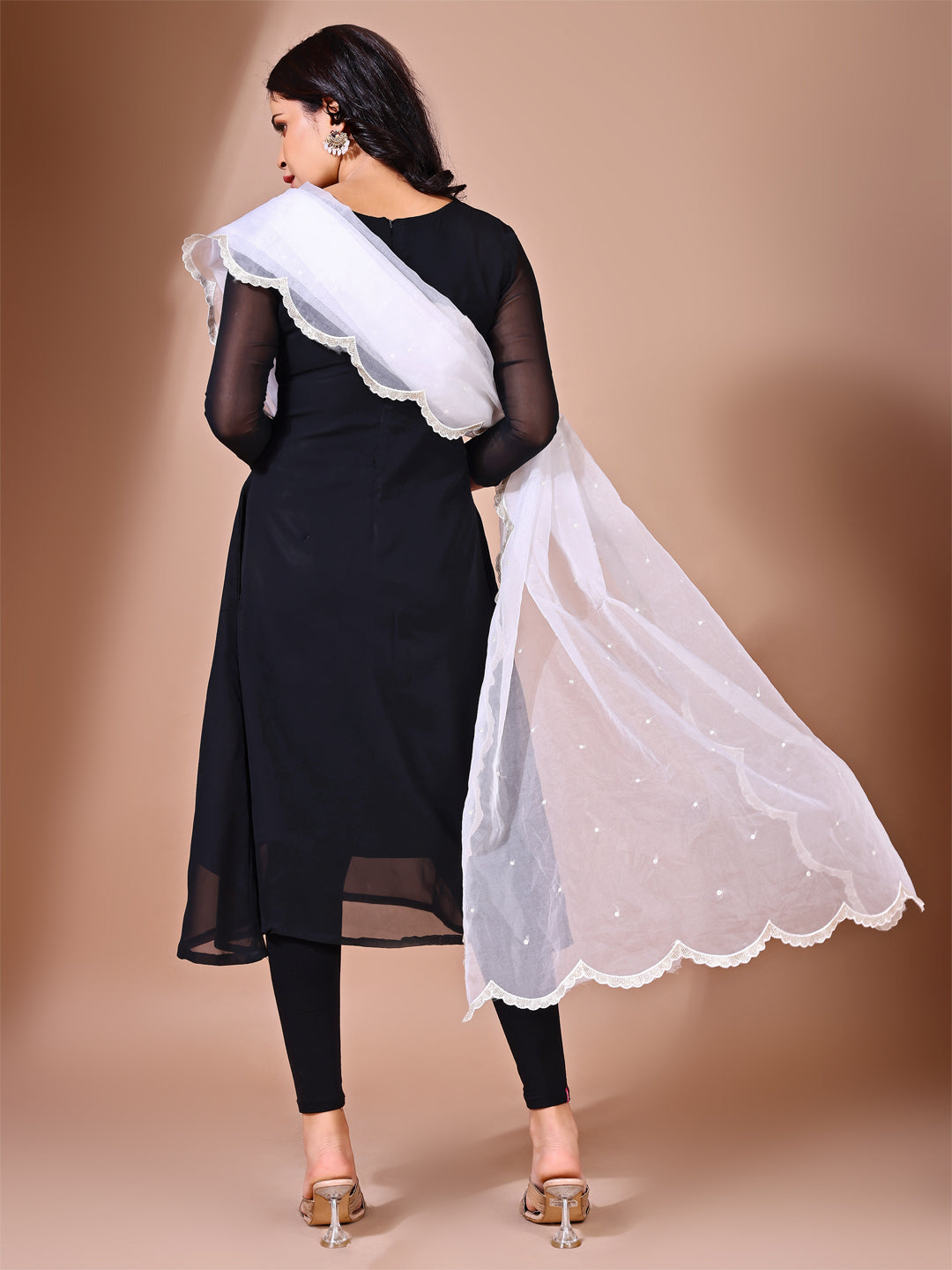 Fancy pose of model wearing a scalloped embroidered dupatta, ideal for wedding events and celebrations.