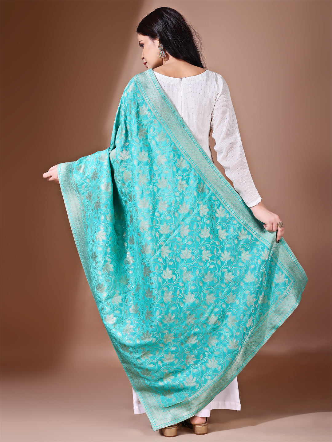 Fancy pose of model wearing an elegant sea green Banarasi silk dupatta, perfect for weddings and special events.