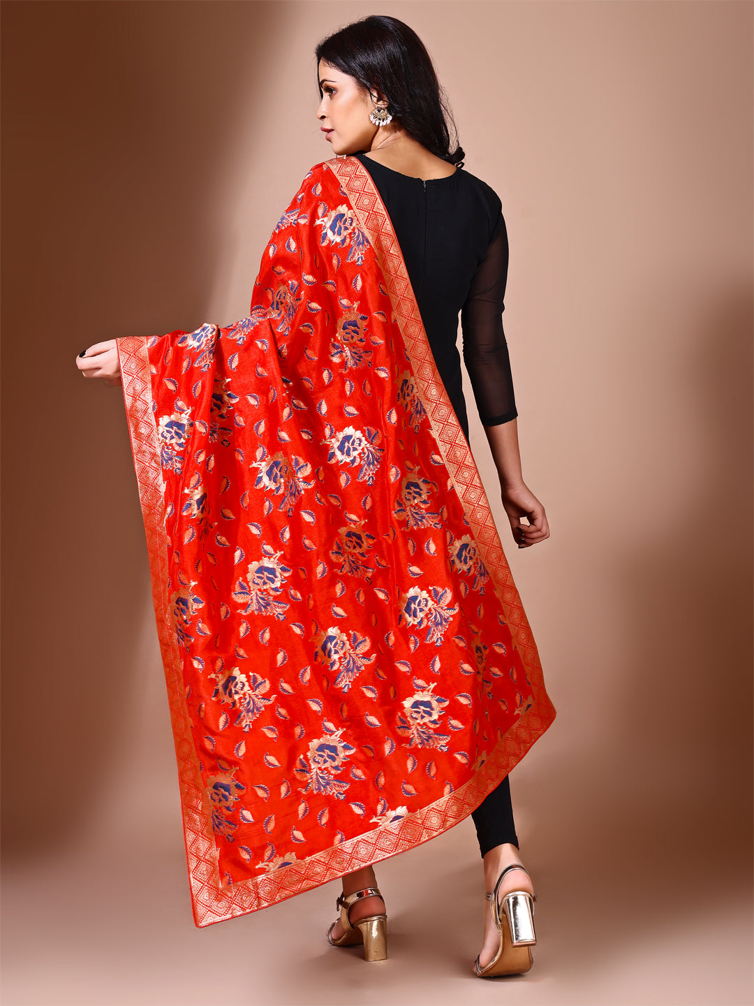 Model in a fancy pose wearing a sindoori Banarasi bridal dupatta, ideal for wedding wear.