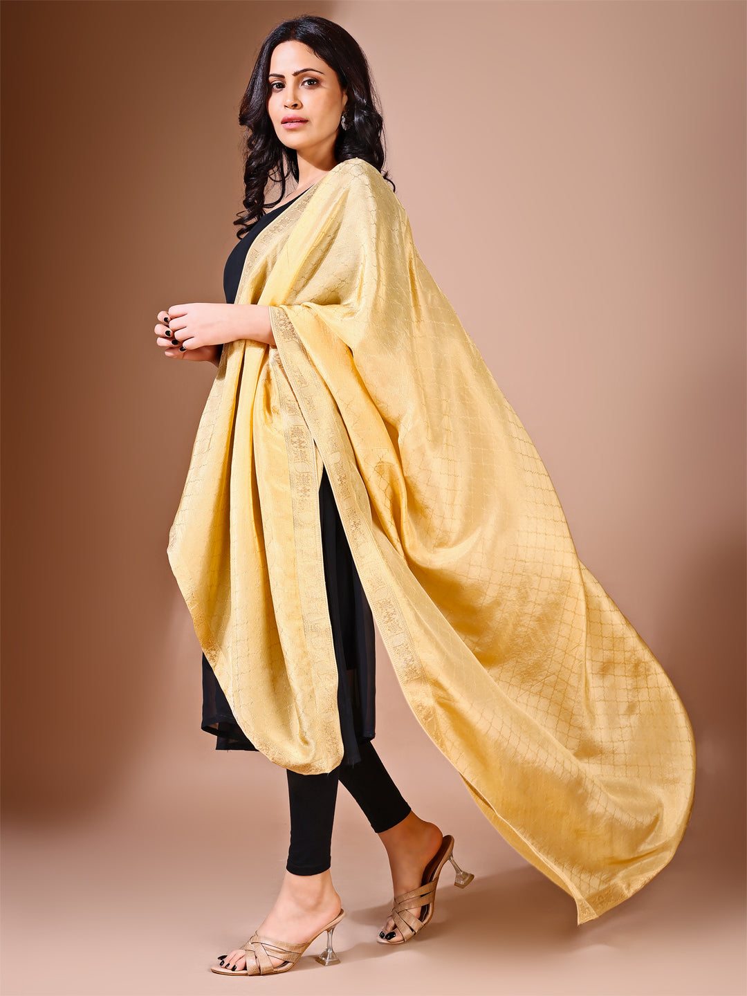 Fancy pose of model in a golden essence dupatta, perfect for weddings and ceremonial gatherings.