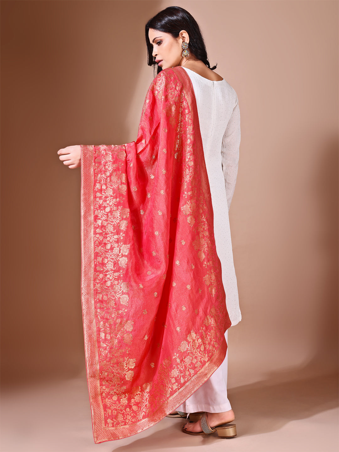 Model in a fancy pose wearing a toamto Banarasi bridal dupatta, ideal for wedding wear.