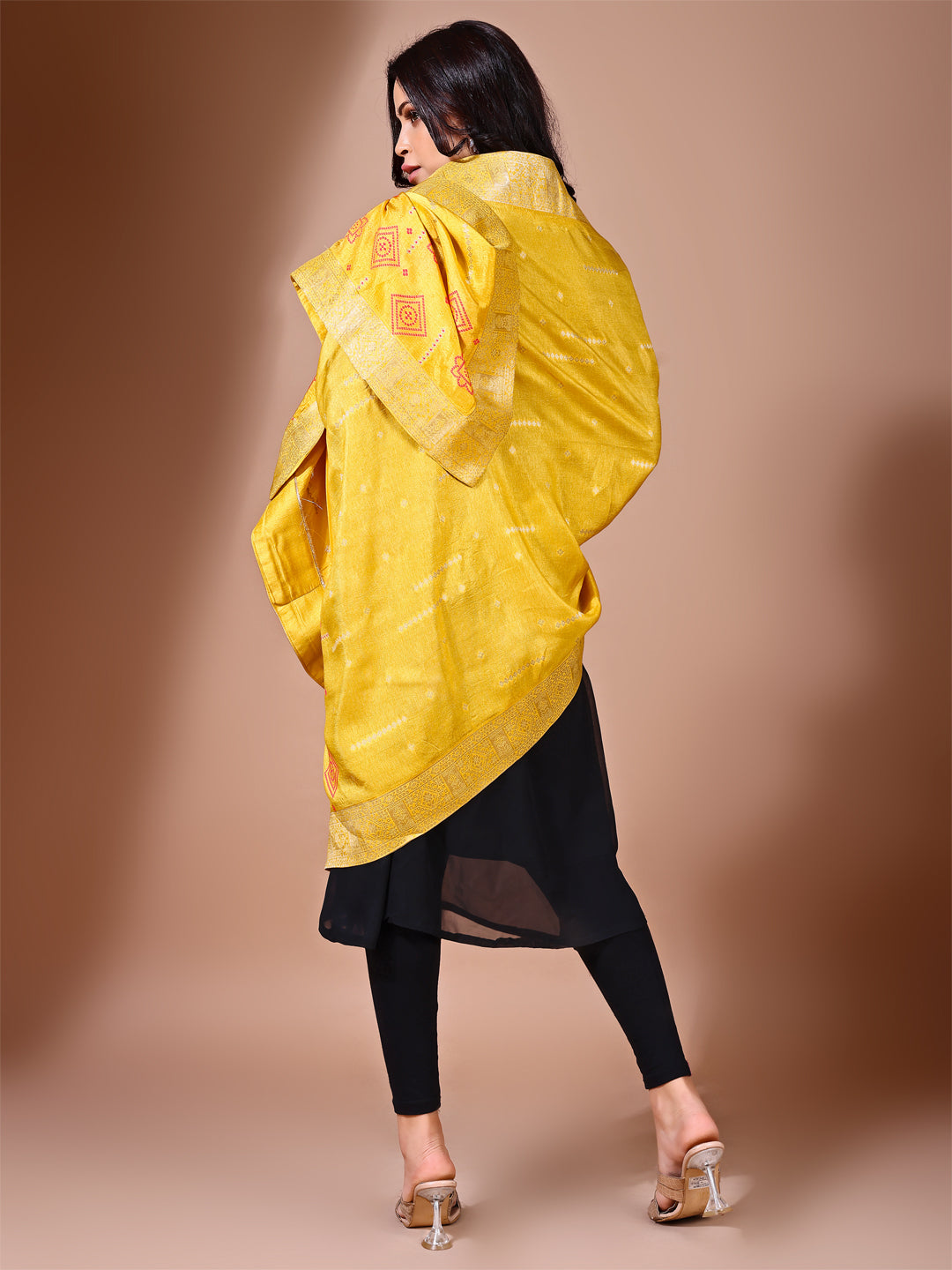 Model in a fancy pose wearing a yellow Banarasi bridal dupatta, ideal for wedding wear.