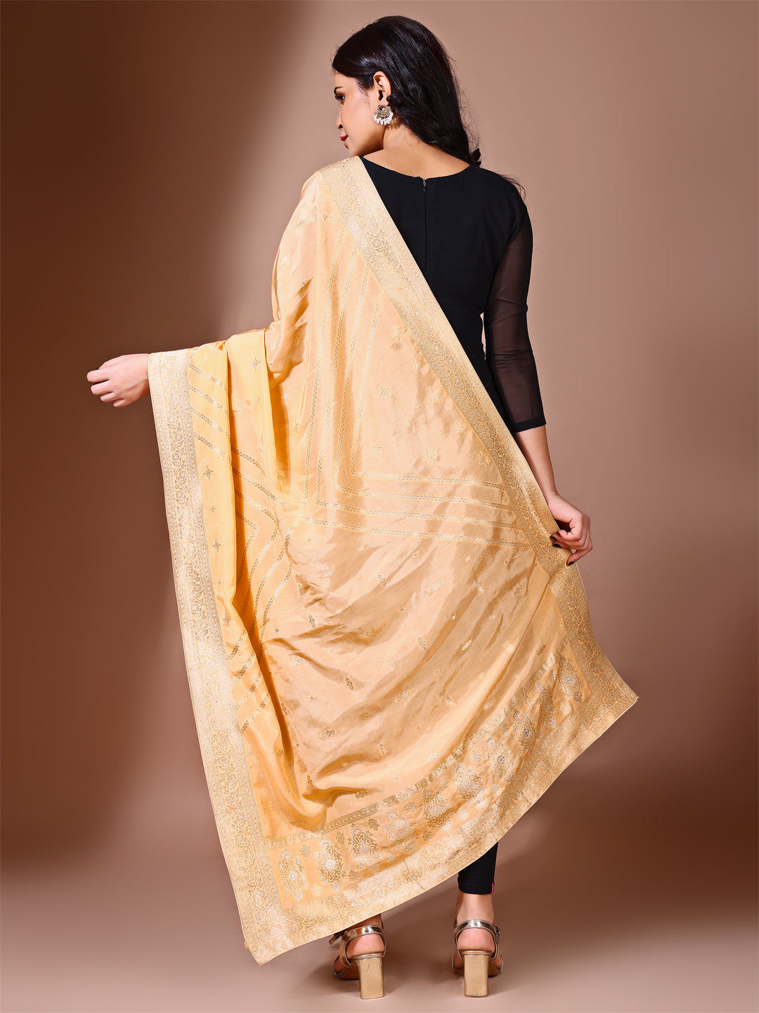 Model in a fancy pose wearing a yellow Banarasi bridal dupatta, ideal for wedding wear.