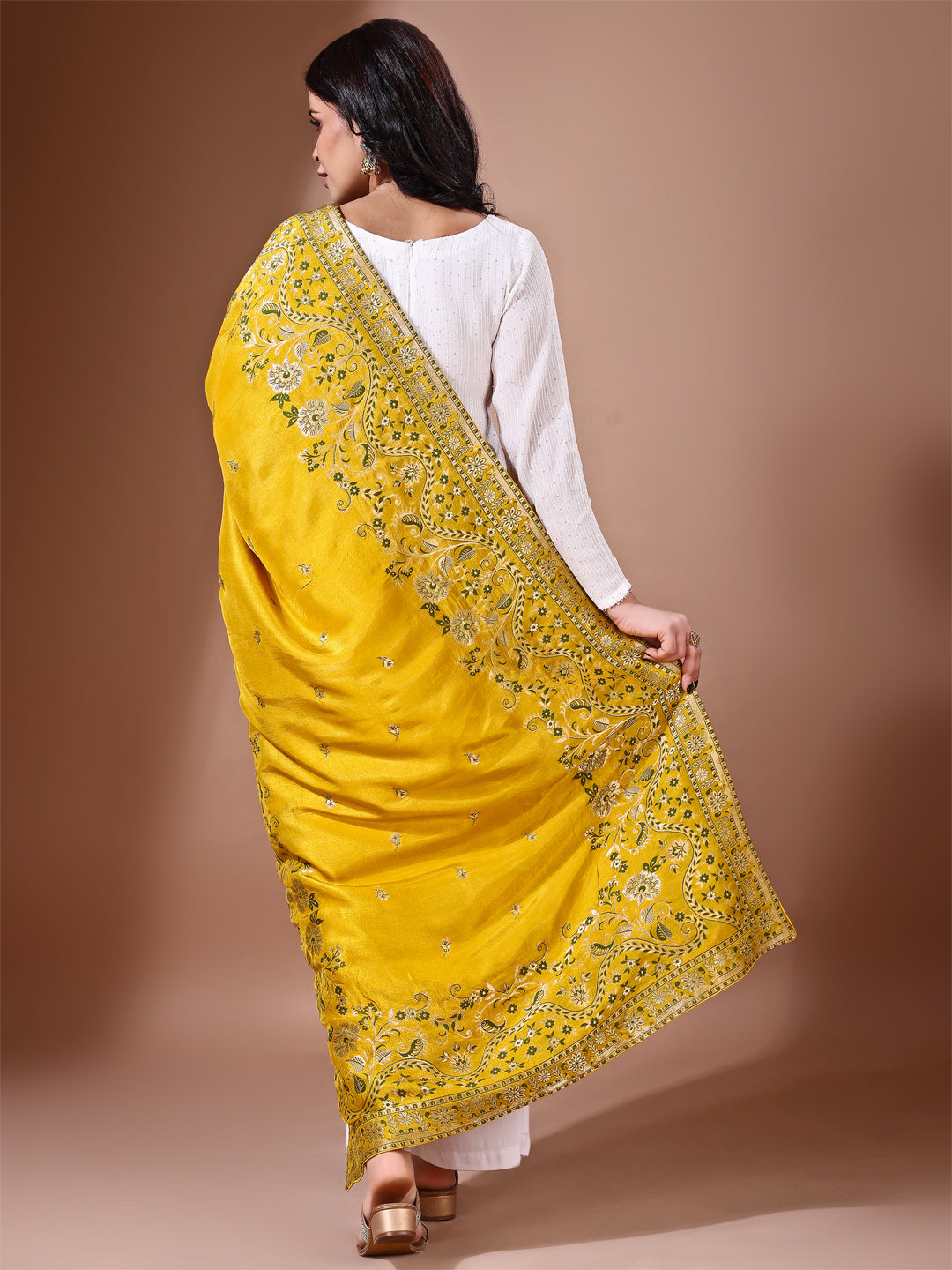 Model in a fancy pose wearing a yellow Banarasi bridal dupatta, ideal for wedding wear.