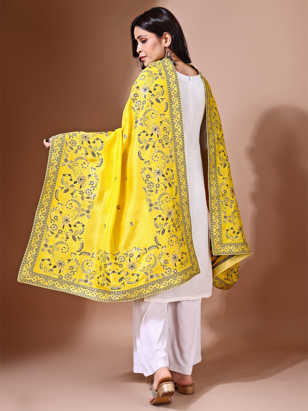 Model in a fancy pose wearing a yellow Banarasi bridal dupatta, ideal for wedding wear.